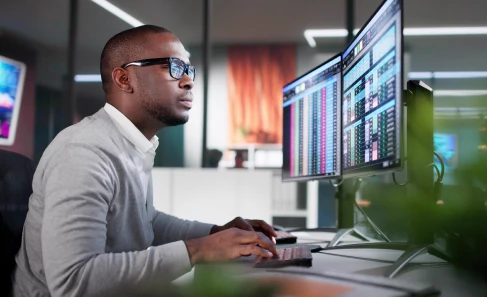 man on computer looking at screens