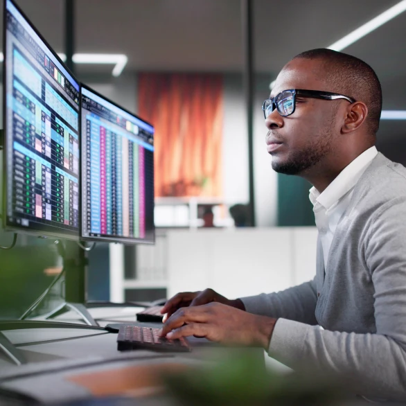 man on computer looking at screens