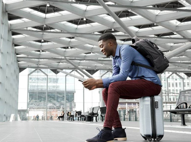 man sitting on luggage