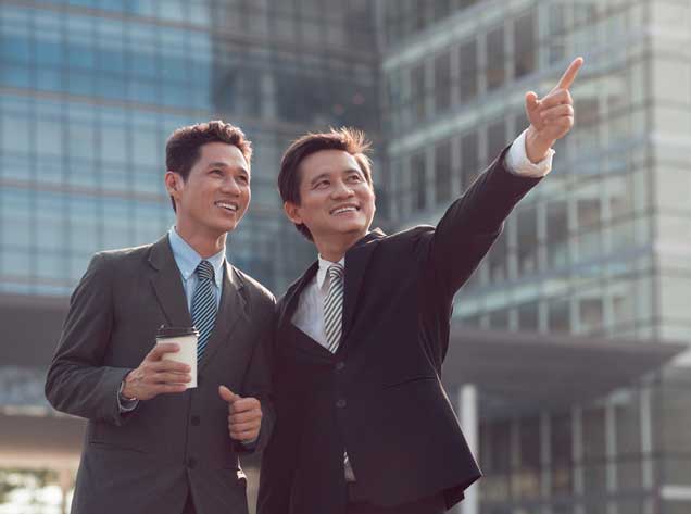 two men standing in front of a building