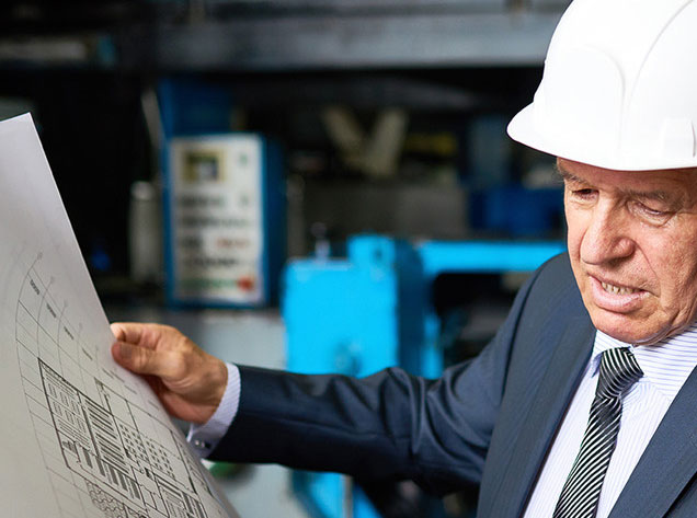 man reviewing building plans