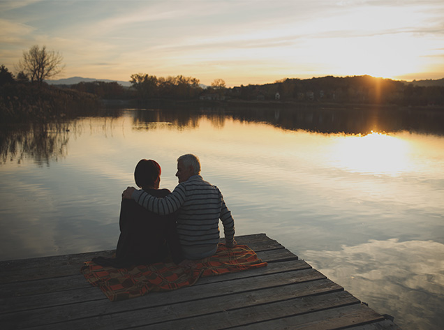 man and woman sitting on a dock
