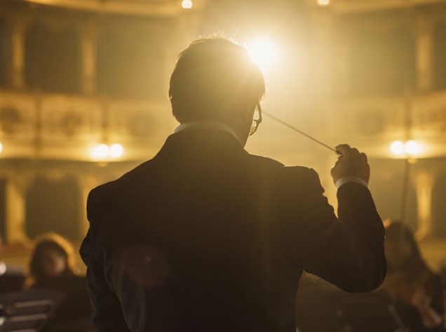 Conductor leading an orchestra
